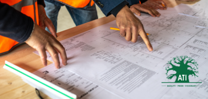 Two industrial workers in safety vests reviewing engineering blueprints, representing Millwright apprenticeship training