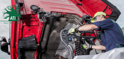 Qualified tractor mechanic servicing agricultural machinery, trained through Artisan Training Institute's tractor mechanic apprenticeship