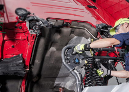 Qualified tractor mechanic servicing agricultural machinery, trained through Artisan Training Institute's tractor mechanic apprenticeship