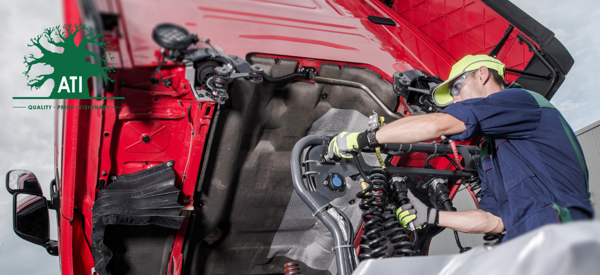 Qualified tractor mechanic servicing agricultural machinery, trained through Artisan Training Institute's tractor mechanic apprenticeship