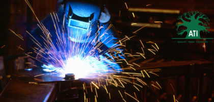 Boilermaker apprentice welding steel with bright arc sparks flying, Artisan Training Institute