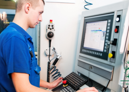 Instrument mechanician apprentice operating a CNC machine control panel, Artisan Training Institute